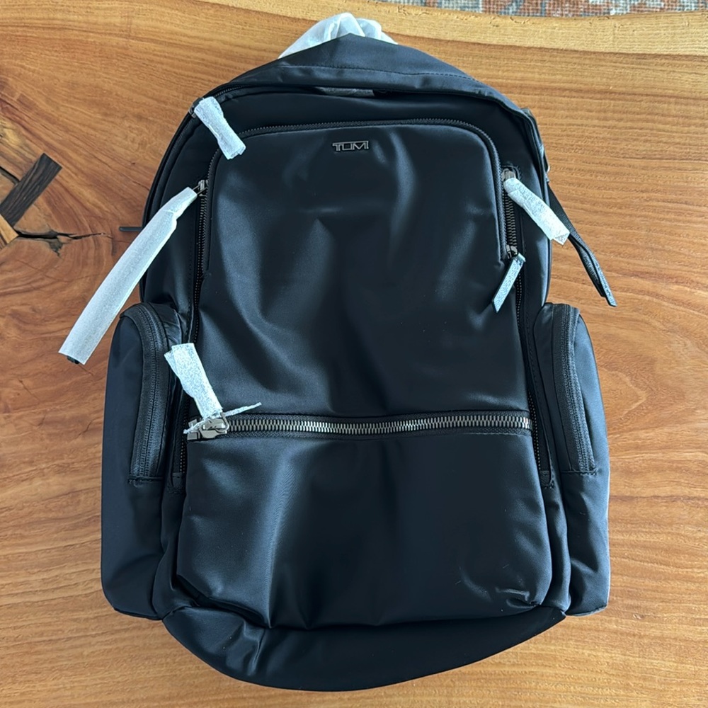 Brand New Tumi Voyageur Black/chrome backpack. Perfect for travel/work.